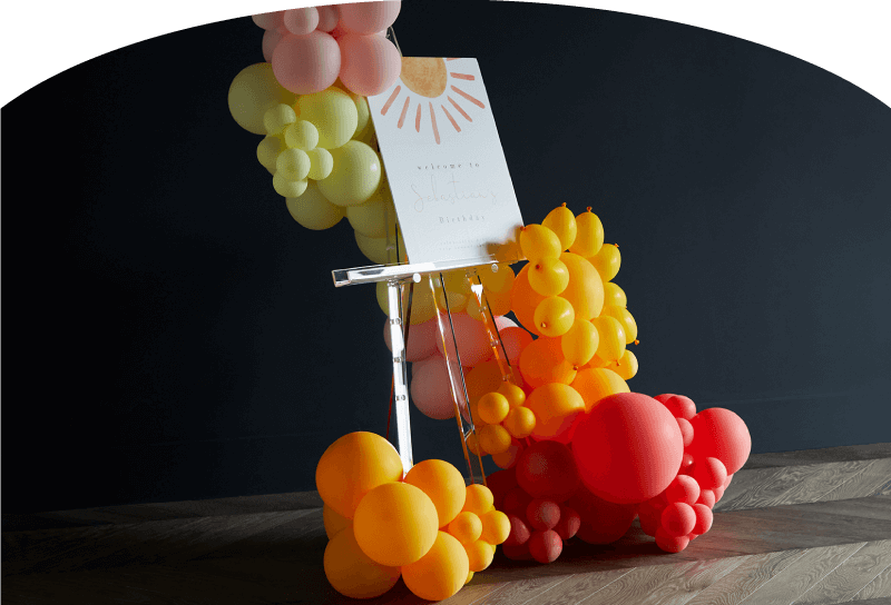 Float Balloons Hero Image pink background lady with balloons 